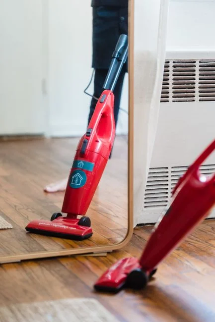 An Asian couple enjoys cleaning their home together, creating a bright and cheerful mood.